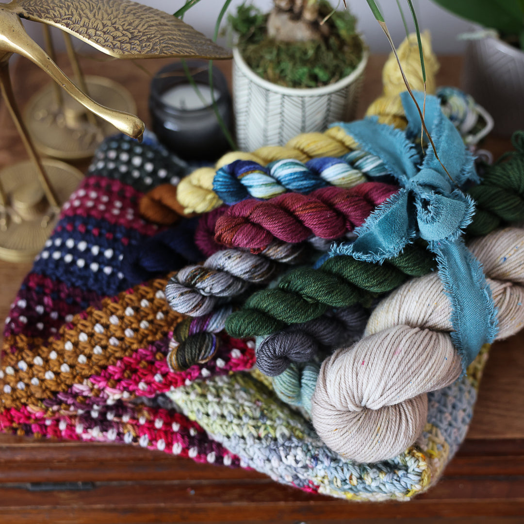 A multi colored crochet cowl pattern with hand dyed mini yarn skeins available as a kit.