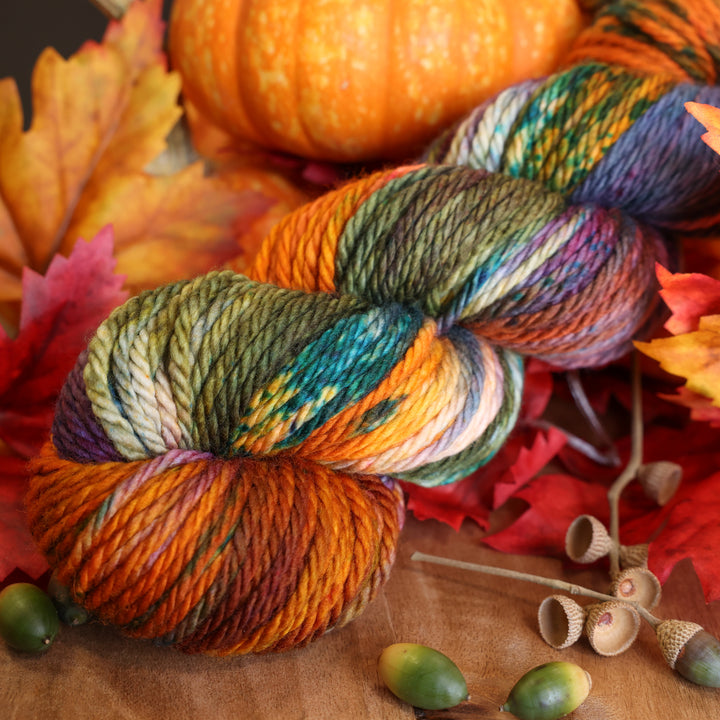 A skein of Upstate Bulky Yarn on table with fall decor.