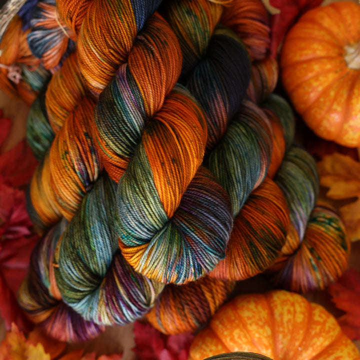 Upstate Sport Yarn laying on orange fall themed decor