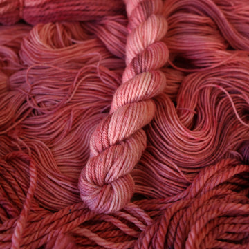 light pink mini-2 yarn with more unwound light pink yarn underneath.