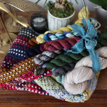 A multi colored crochet cowl pattern with hand dyed mini yarn skeins available as a kit. 