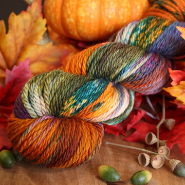 A skein of Upstate Bulky Yarn on table with fall decor.