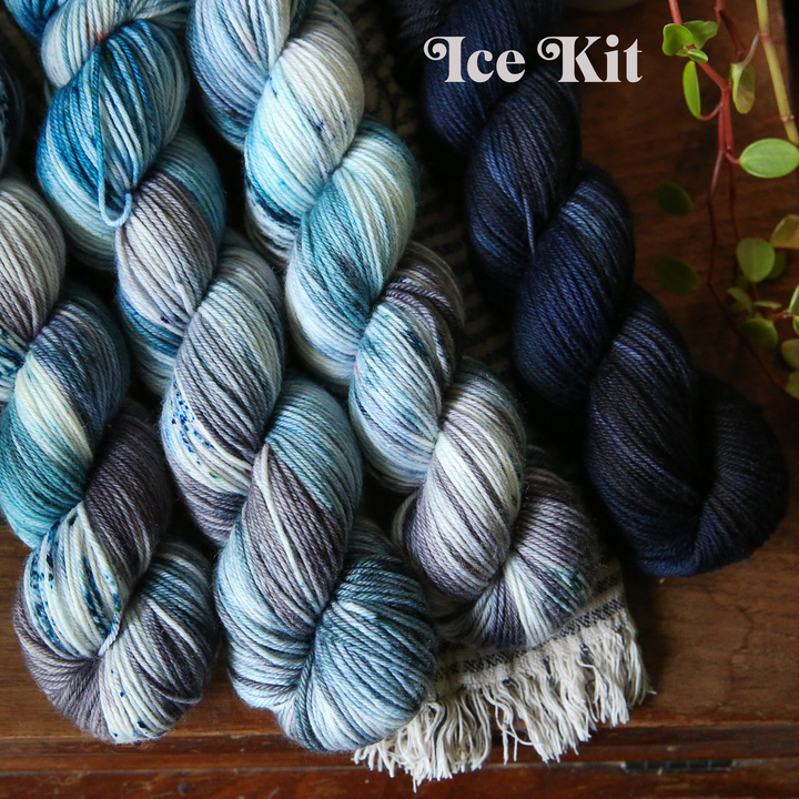 yarn skeins in mixed colors on a wooden surface