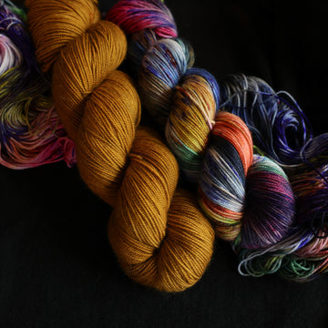 Jeykll and Hyde Sport set sitting on top of multicolored yarn.